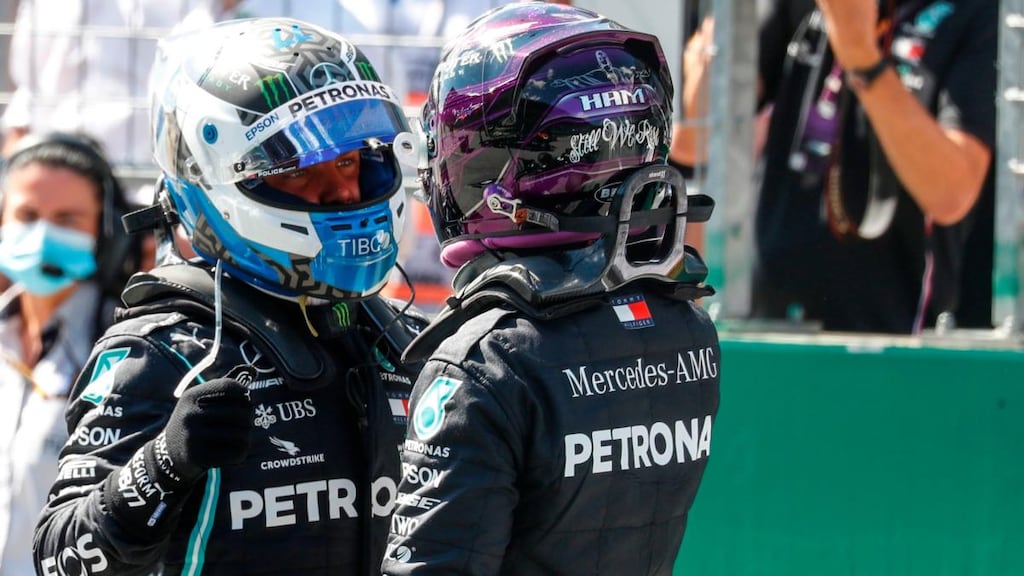Lewis Hamilton (R) congratulates Mercedes teammate Valtteri Bottas. Photograph: Leonhard Foeger/Getty/AFP