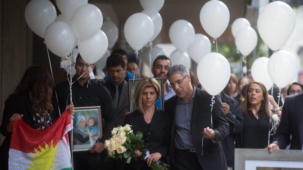 Tima Kurdi, aunt of late brothers Aylan and Ghalib Kurdi, and her husband Rocco Logozzo walk to the waterfront to release balloons in memory of the boys after a memorial service in Vancouver, British Columbia, Canada. Photograph: Darryl Dyck/The Canadian Press via AP