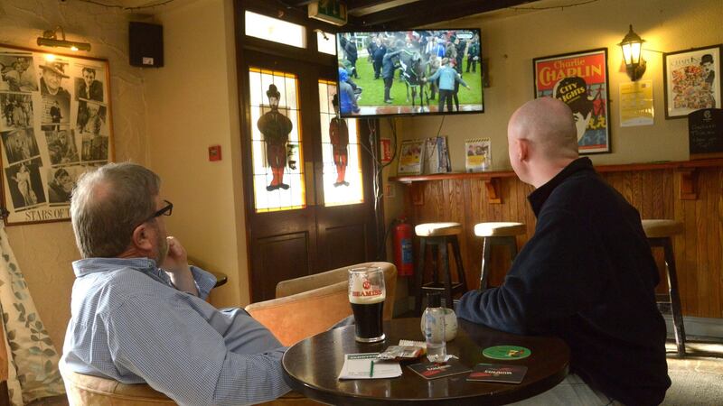 Chaplin’s bar publican John Collins with punter Dan Gallagher: ‘A lot of my regulars, a good few that had medical issues, for example, still haven’t frequented the pub, and I can understand that,’ says Collins. Photograph: Denis Boyle