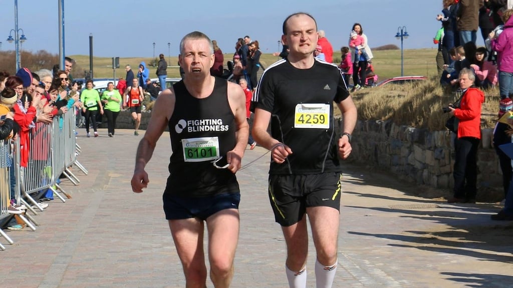 Tony Ward with his running guide, Darragh McDaid. According to Ward, ‘I’m lucky in that I’m stubborn and I have a great network of family and friends around me who row in behind my stubbornness and help me to do these things.’