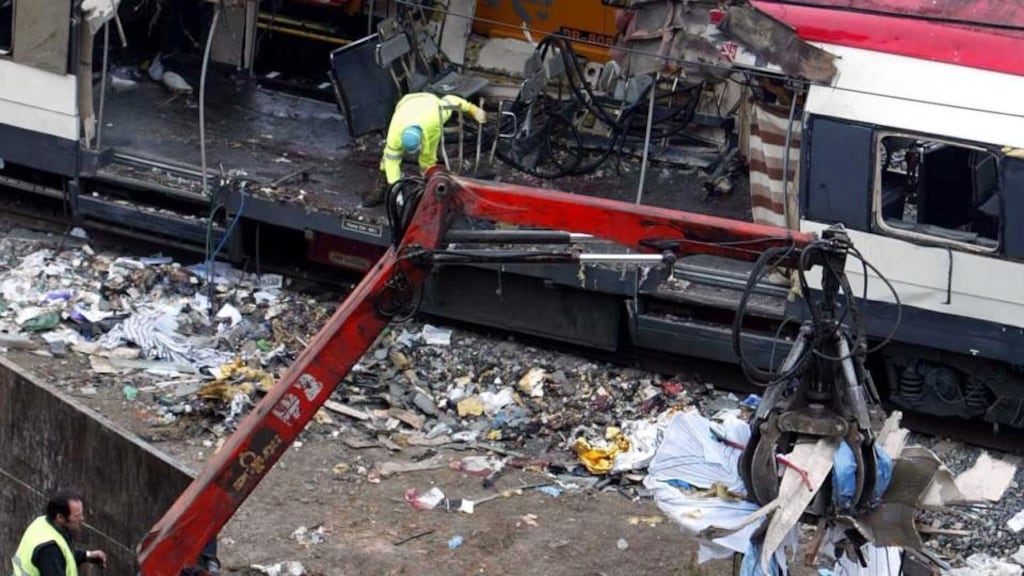 Railway workers remove debris from the wreckage of a public train near to Atocha train station in Madrid, March 12th, 2004. Photograph: Reuters