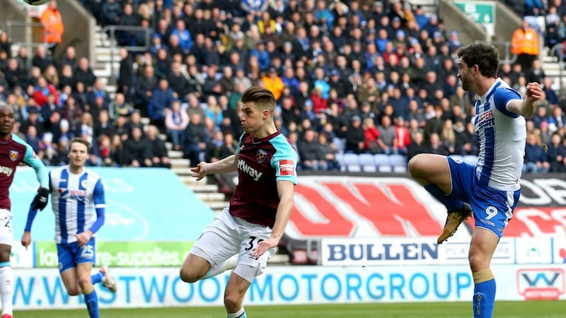 Will Grigg scores Wigan Athletic’s first goal during the FA Cup fourth-round match against West Ham United. Photograph: Jan Kruger/Getty Images