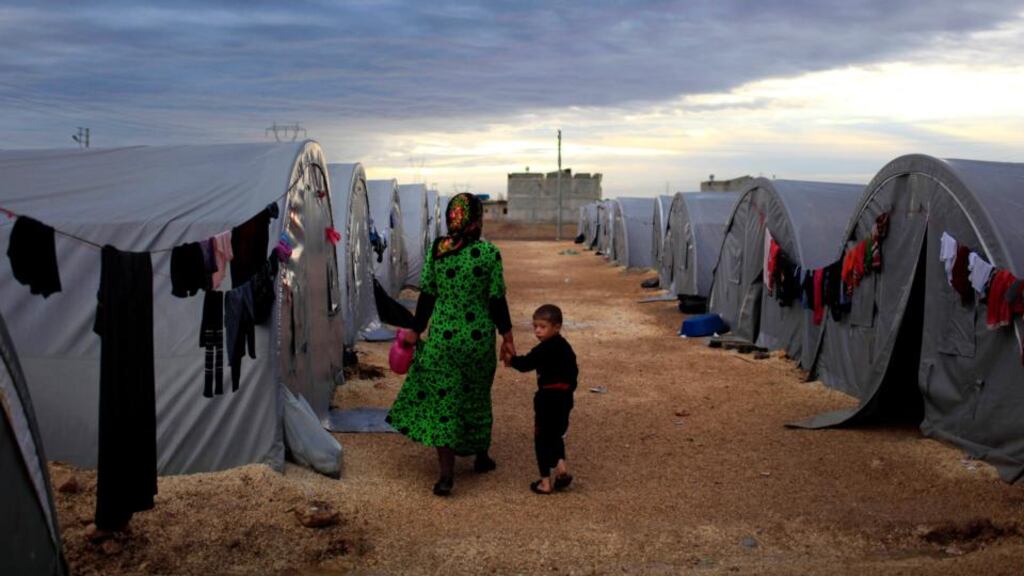 A Kurdish refugee mother and son from the Syrian town of Kobani in a camp in the southeastern town of Suruc, Turkey, on the Turkish-Syrian border at the weekend. Photograph: Gokhan Sahin/Getty Images