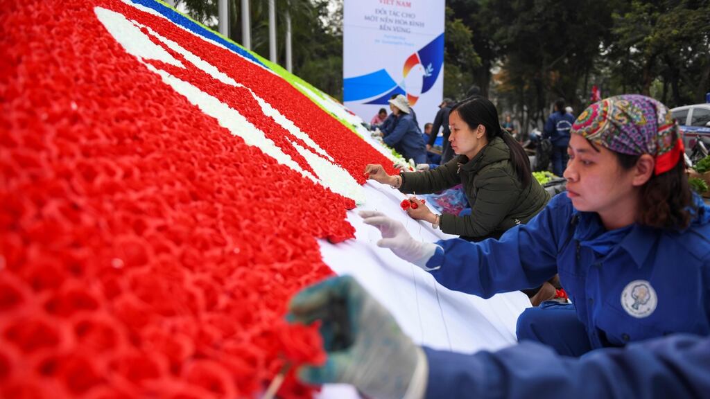 Workers make a North Korean and  US flag with paper flowers in Hanoi as US president Donald Trump gets set to meet North Korean leader Kim Jong-un. Photograph: Jewel Samad