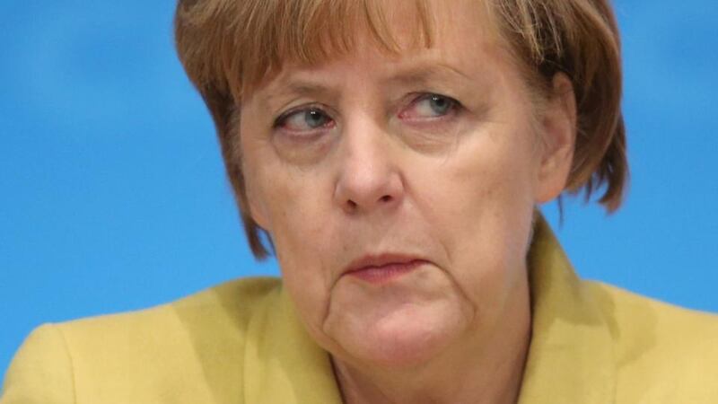 Sister act: Angela Merkel’s buttoned-down sobriety achieves the same end in her world as Dolly Parton’s sequinned dazzle does in hers: it triggers emotional appeal. Photograph: Sean Gallup/Getty