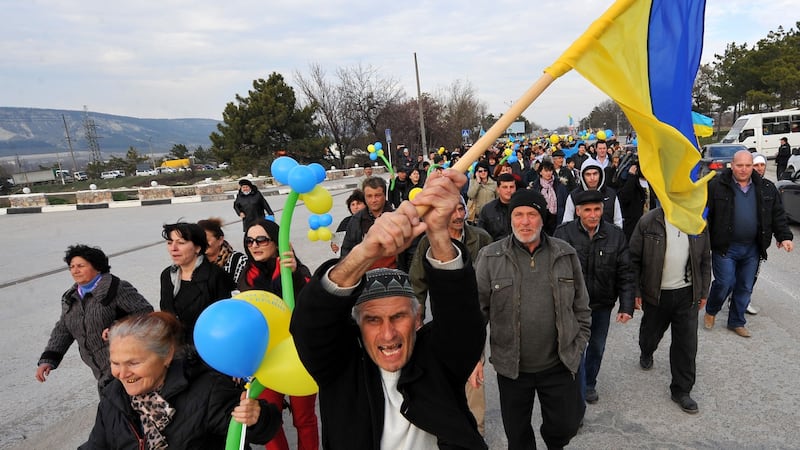 Members of the Crimean Tatar community with the Ukrainian flag in Bakhchisarai, south of Simferopol, on March 14th, 2014, two days before the rigged referendum to join Russia. Photograph: Viktor Drachev/AFP/Getty Images
