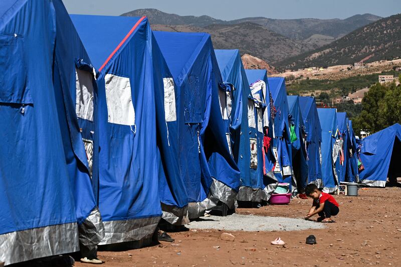 A child plays next to relief tents near a military field hospital in the village of Asni near Moulay Brahim in al-Haouz province in the High Atlas mountains. Photograph: Philippe Lopez/AFP via Getty Images