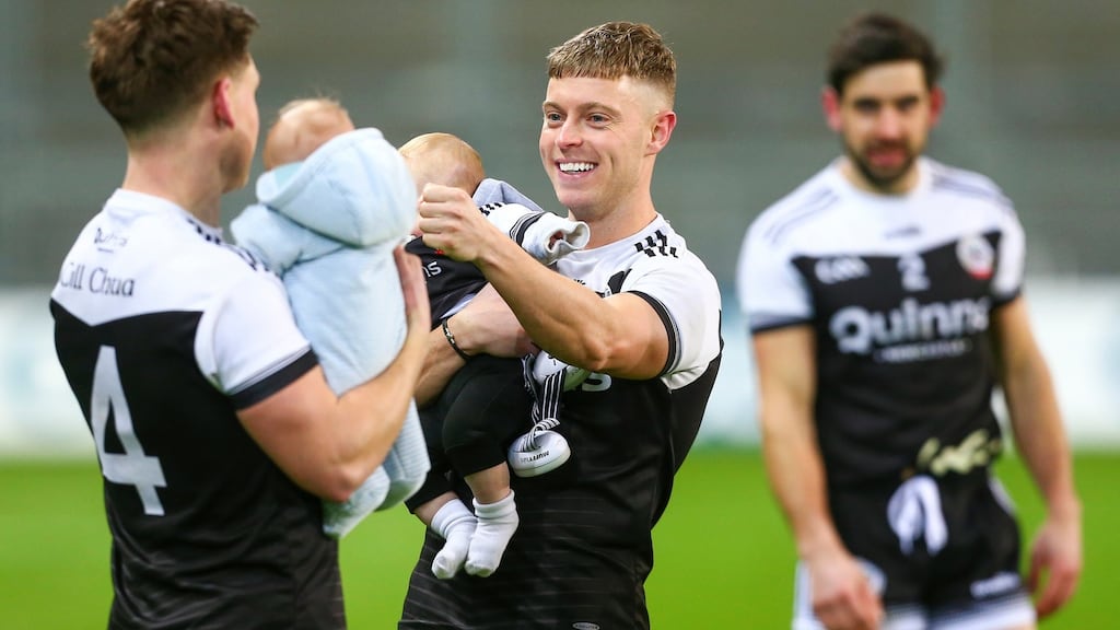 Kilcoo’s Jerome Johnston with his son Lár and Aaron Branagan after his side’s All-Ireland final win. Photograph: Ken Sutton/Inpho