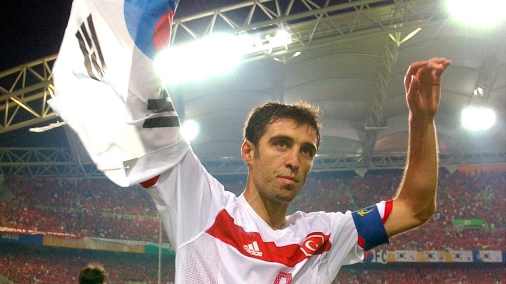 Turkey’s Hakan Sukur holds a South Korean flag at the end of the 2002 World Cup third place playoff. Photograph: AP