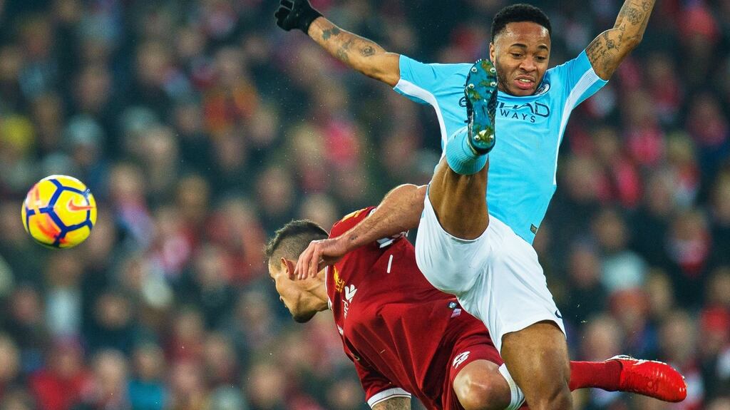 Liverpool’s Dejan Lovren in action against Manchester City’s Raheem Sterling. Photograph: Peter Powell