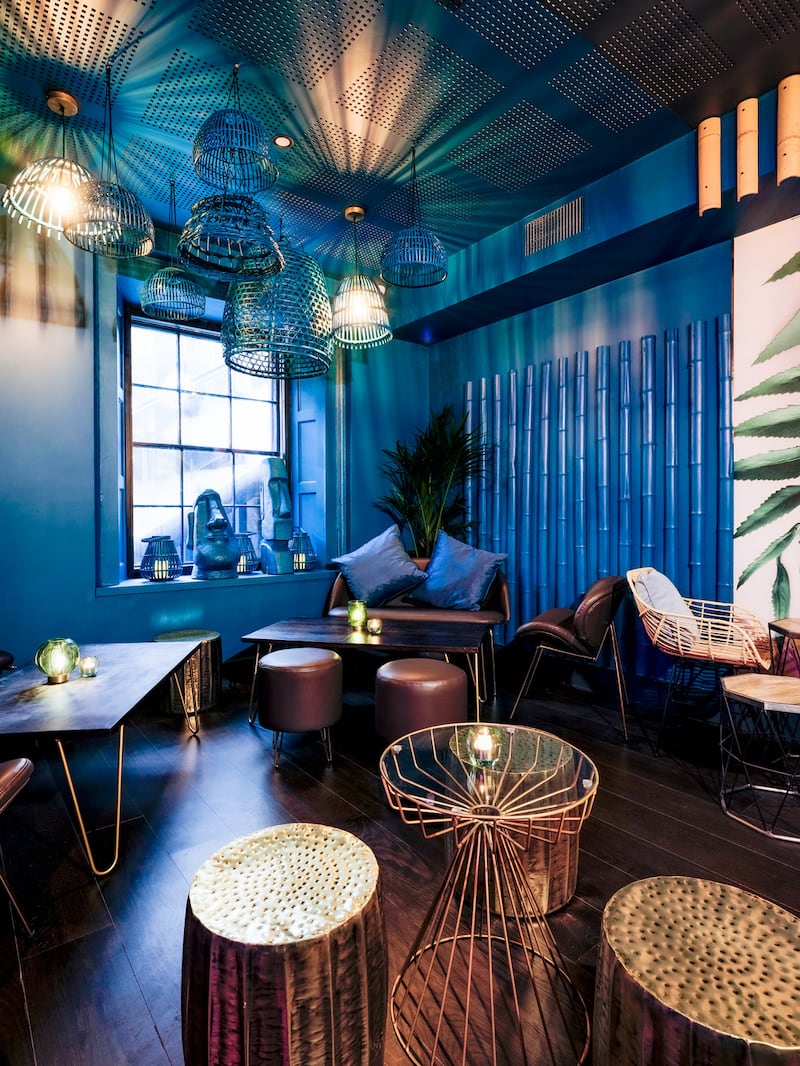 ’Ohana tiki bar: its teal and crystal-blue walls are broken by sections of bespoke wallpaper of oversized palm leaves