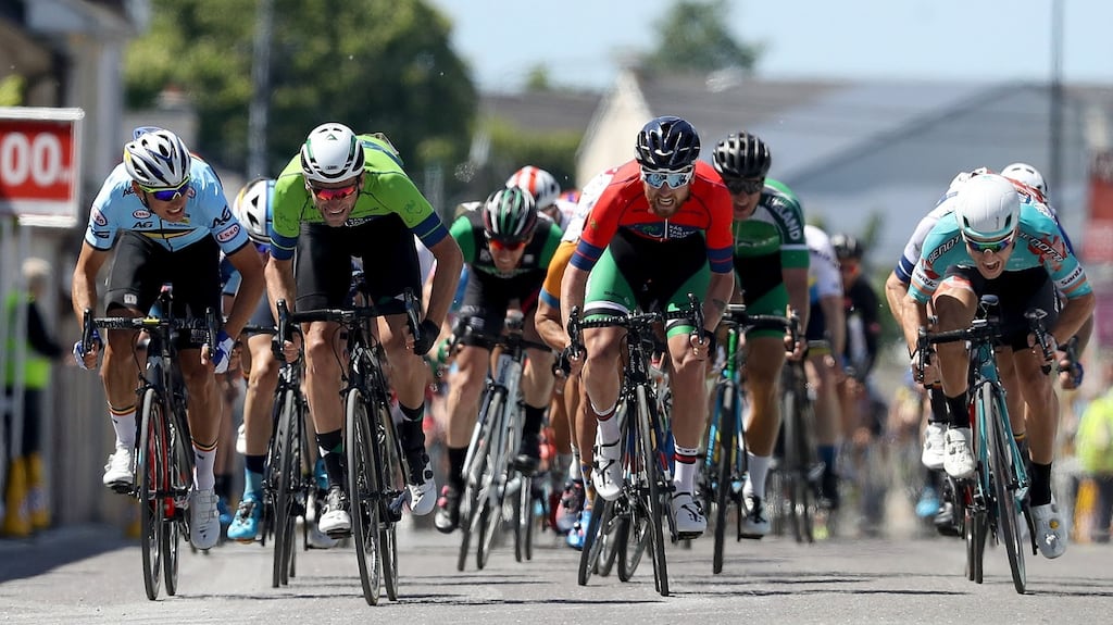 Luuc Bugter (in green) takes stage three of the Rás Tailteann into Listowel. Photograph: Bryan Keane/Inpho