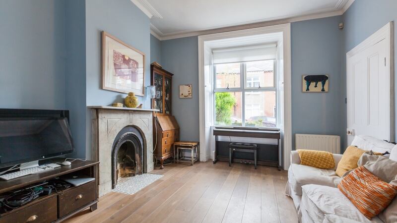 The living room. The house has its original four-panel doors.