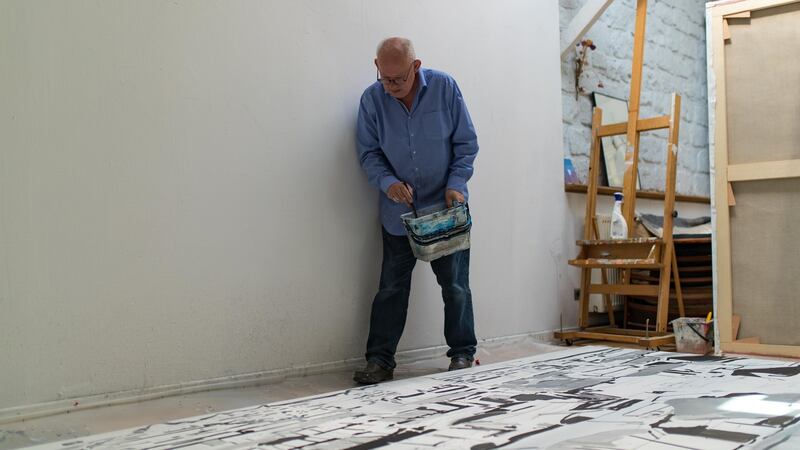 Brian Maguire working on his Sudan paintings in his studio