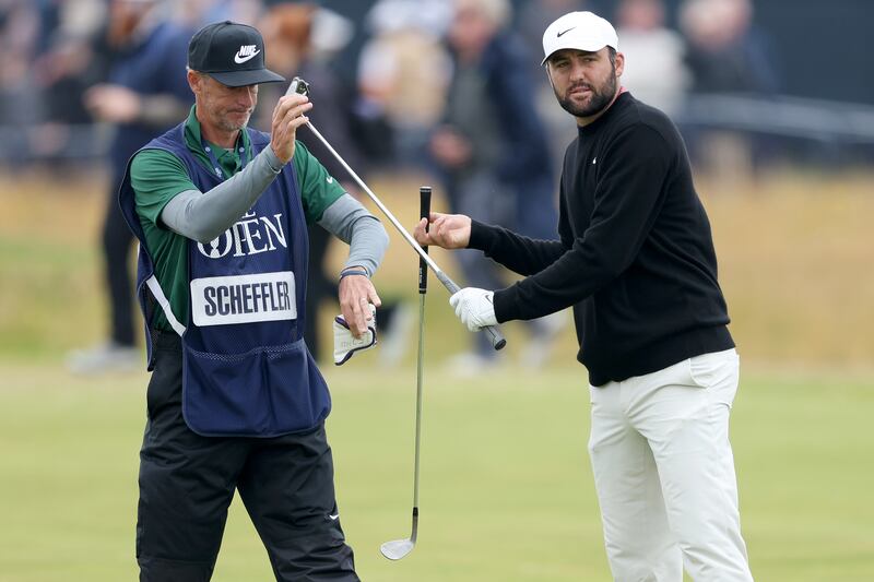 Scottie Scheffler of the United States interacts with his caddie Ted Scott at Royal Troon. Photograph: Warren Little/Getty