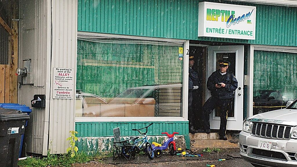Police stand in front of the Reptile Ocean store in Campbellton, New Brunswick, where the two young boys died. Photograph: Tim Jaques/Reuters