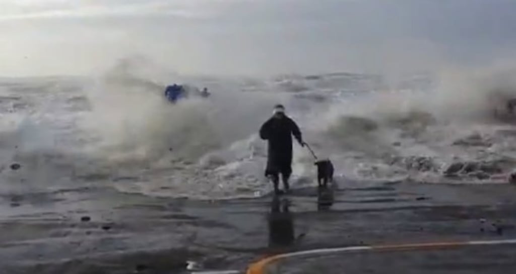 A screen grab of the YouTube clip showing a woman running from a large wave in Tramore, Co Waterford.