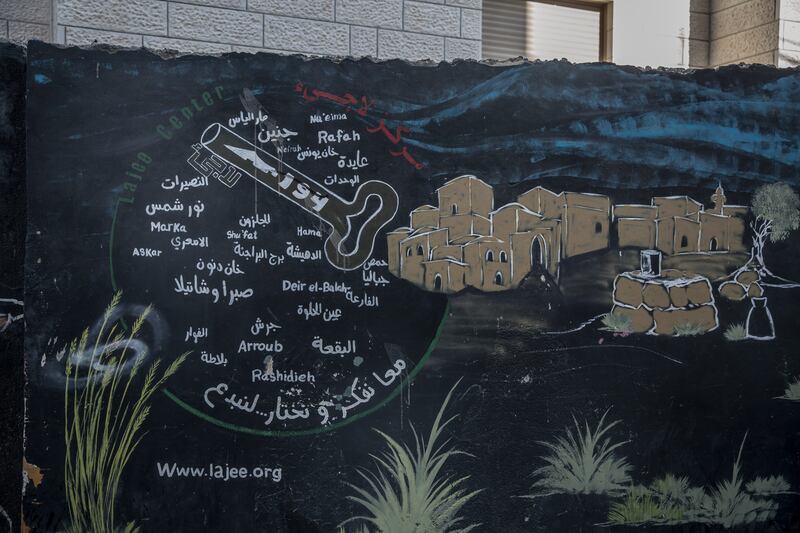A wall mural features a black key – a symbol of the Palestinian belief in the right to return to their families’ former homes and land