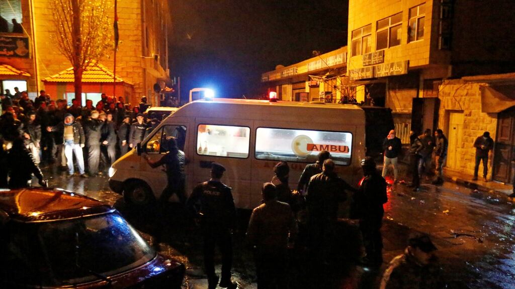 Policemen and an ambulance in the vicinity of the crusader castle of Al Karak. Muhammad Hamed/Reuters
