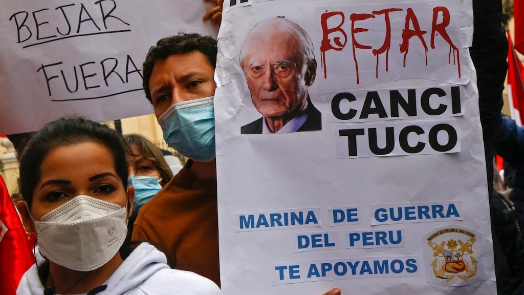 People hold signs that read ‘Béjar Out’. Minister’s resignation is the latest setback for new president Pedro Castillo, who faces a battle to have his cabinet approved by the opposition-dominated congress. Photograph: Gian Masko/AFP via Getty