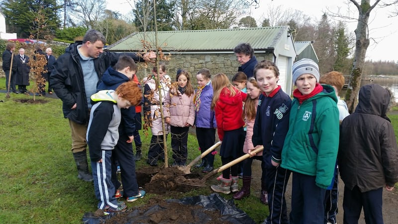 Children get to work planting trees in Mountshannon. Photograph: Vera O’Rourke