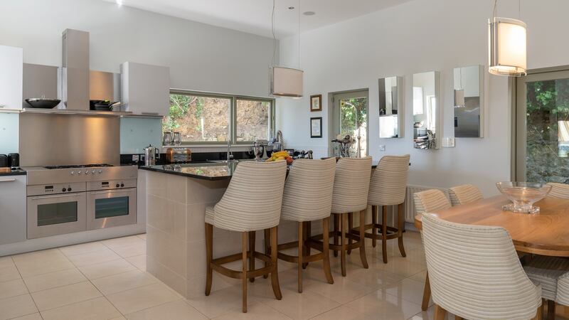 Industrial-style contemporary kitchen – all granite, gloss and stainless steel