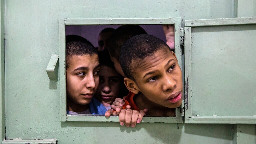 Young boys peer from a crowded cell at a prison for former Islamic State members run by Kurdish-led forces in Hasaka, in northeast Syria. Photograph: Ivor Prickett/The New York Times