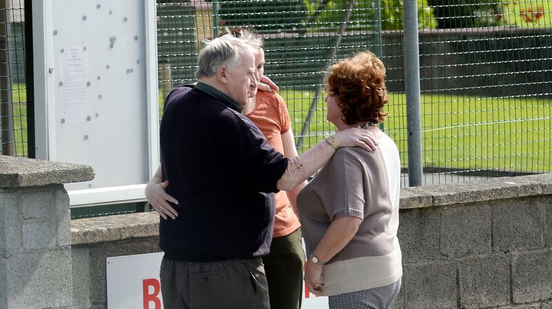 People comfort each other outside Castlerahan National School, Ballyjamesduff, Co Cavan. Photograph: Dara Mac Dónaill/The Irish Times