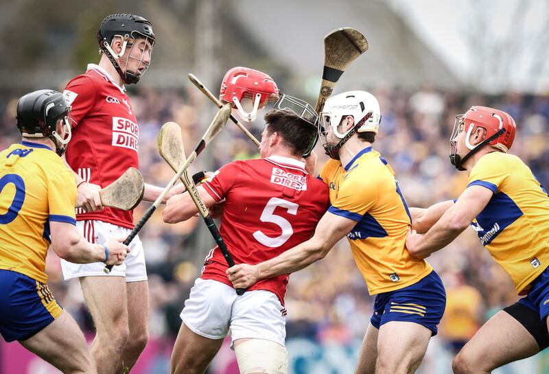 Cork's Ciaran Joyce sees his helmet come off after a challenge from Aidan McCarthy of Clare during their game in Ennis. Photograph: Tom Maher/Inpho
