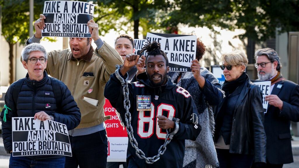 Demonstrators rally outside the NFL owners meeting in New York City. Photo: Brendan McDermid/Reuters