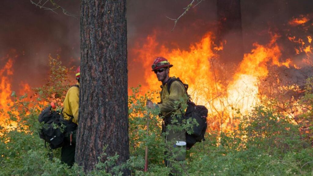 Firefighters keep watch over a fire while battling the Carlton Complex Fire near Winthrop in Washington state. Photograph: David Ryder/Reuters.