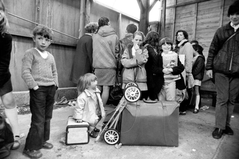 Northern Ireland, July 1972. Children waiting for the train in Belfast as families flee from the bombs and bullets. Photograph:  Mirrorpix via Getty Images