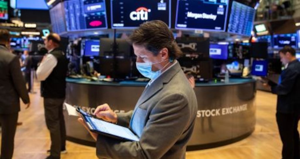 Traders on the floor of the New York Stock Exchange on Wall St