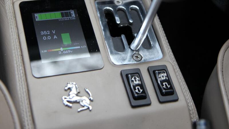 The gated manual gearbox is blocked off to allow the automatic transmission. Beside the gate is a high tech display that reads out the electrical status of the car, but other than that it’s all 1980s