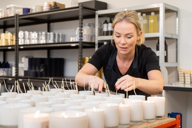 Amy Herbert of The Little Wax Company filling an array of candles