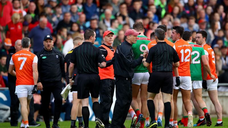McGeeney speaks to referee Maurice Deegan at half-time. Photo: James Crombie/Inpho