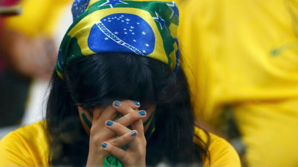 A Brazil fan can’t bear to watch during the rout at the hands of Germany in Belo Horizonte. Photograph: Eddie Keogh / Reuters