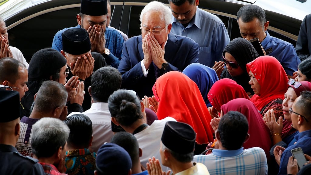 Malaysia’s former prime Minister, Najib Razak, offers a prayer as he arrives at the high court in Kuala Lumpur on Wednesday. Photograph: Lai Seng Sin/Reuters