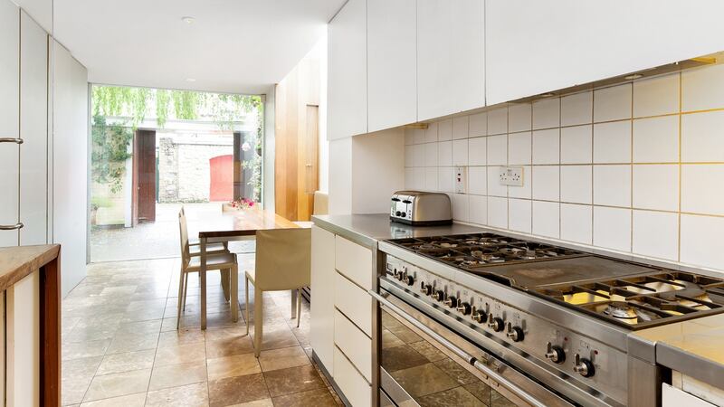 Kitchen opening into dining area in extended area in the front