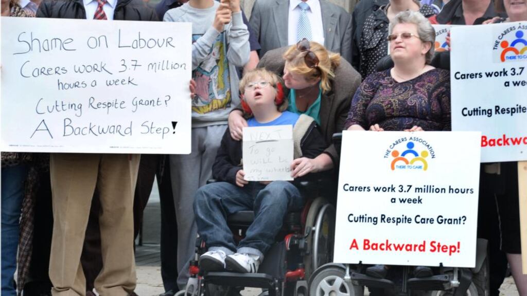 Fran Kane with her son JJ Kane, from Tallaght , and Carolyn Akintola, Tallaght, who cares fro her mother Elsie, who is on peretonial dialysis three time a day, as the Carers Association protested outside Leinster House yesterday.
Photograph: Dara Mac Dónaill