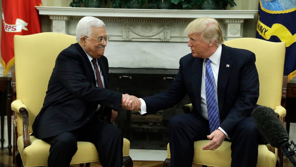 President Donald Trump (right) shakes hands with with Palestinian leader Mahmoud Abbas during their meeting in the Oval Office of the White House. AP Photo/Evan Vucci