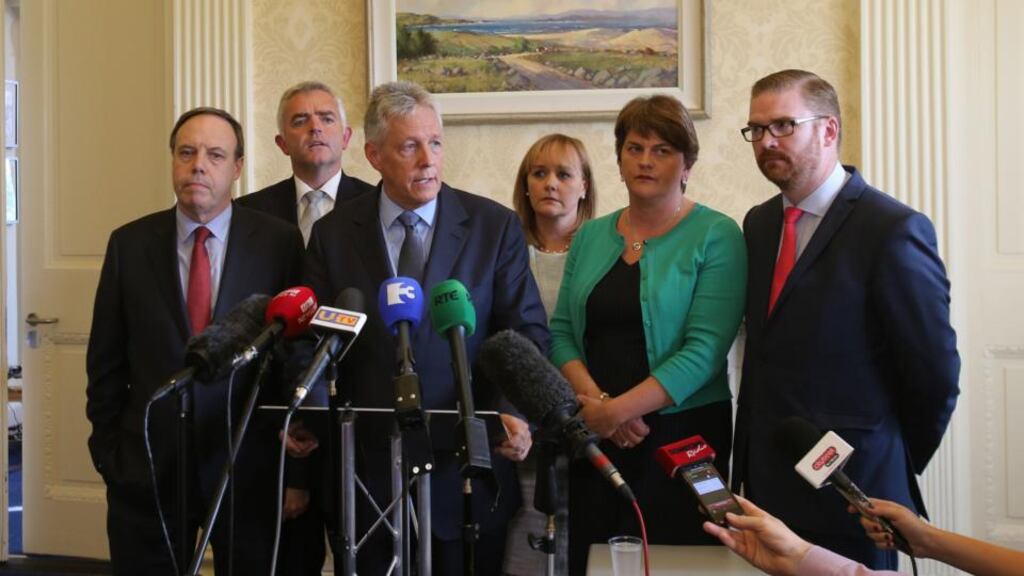 Northern Ireland First Minister Peter Robinson at Stormont, Belfast, with (from left) Nigel Dodds, Johnathan Bell, Michelle Mcilveen, Arlene Foster and Simon Hamilton, announcing  he is standing aside and the majority of his Democratic Unionist ministers are to resign, with Ms Foster to take over as acting First Minister. Photograph: Niall Carson/PA Wire