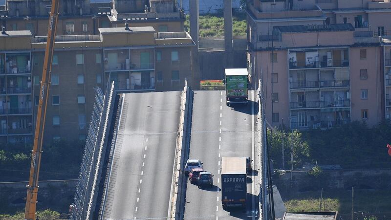 Trucks and cars stand on a part of the collapsed Morandi Bridge a day after the disaster in Genoa, Italy, in which at least 37 were killed, according to Genoa police. Photograph: Luca Zennaro/EPA