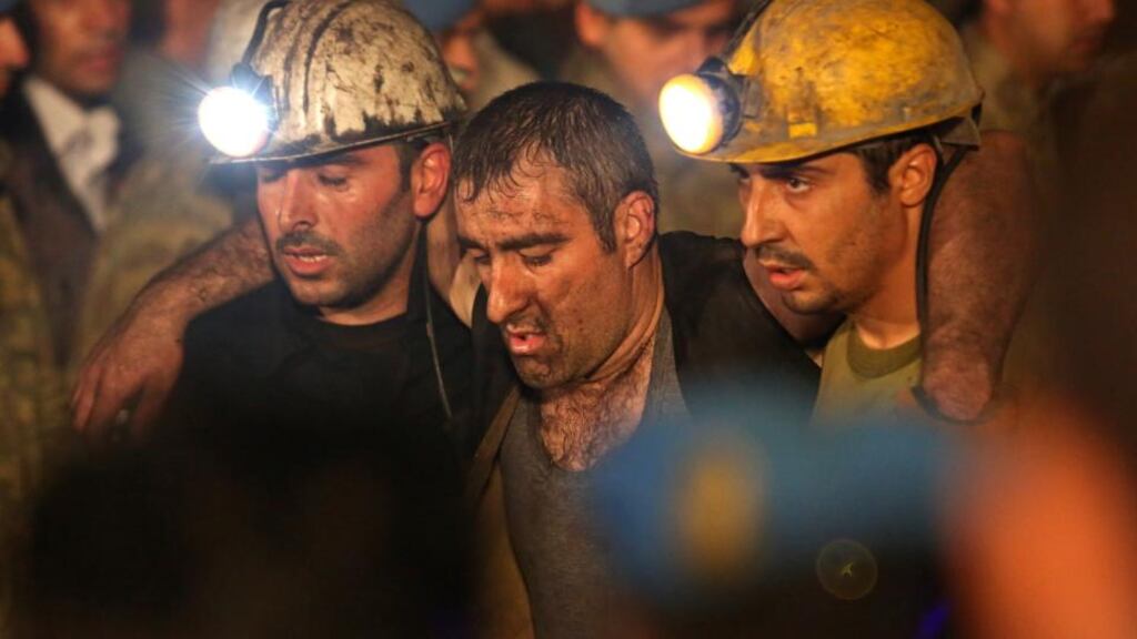 Miners are helped by rescue workers and friends from the coal mine in Soma. The disaster in western Turkey is likely to be the country’s deadliest and is also the worst in a series of incidents in a sector that has seen 30,000 die since 1970. Photograph: Ozgu Ozdemir/Getty Images