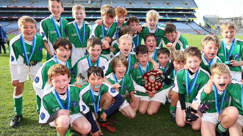 Photograph: Scoil Bhríde captain Luke Mac Giolla Mhuire celebrates with his teammates after they beat Swords Educate Together NS in the Corn an Chéid final at Croke Park. Photograph: Frank McGrath