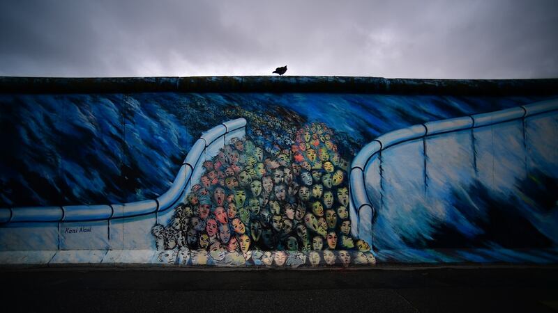A raven sits on top of remaining pieces of the Berlin Wall at the East Side Galleray, an open-air gallery consisting of a series of murals painted directly on the remnants of the Berlin Wall, October 3rd, 2019. Photograph: Alexander Koerner/Getty Images)