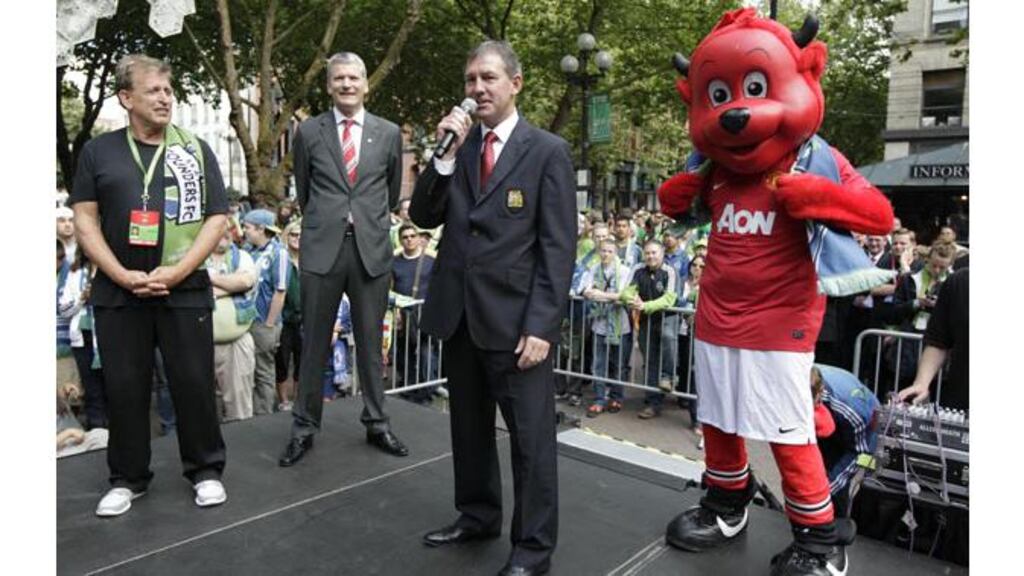 Former Manchester United captain Bryan Robson, seen here addressing fans on the club's Nort American pre-season tour, is considering legal advice after featuring on Channel 4's Dispatches this week. - (Photograph: AP)