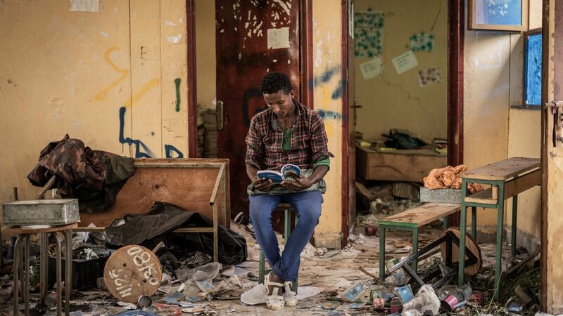 Kindu Fenta (17) reads a book inside a classroom which was allegedly looted by pro-TPLF rebels in Zarima, Ethiopia. Photograph: Amanuel Sileshi/AFP via Getty Images