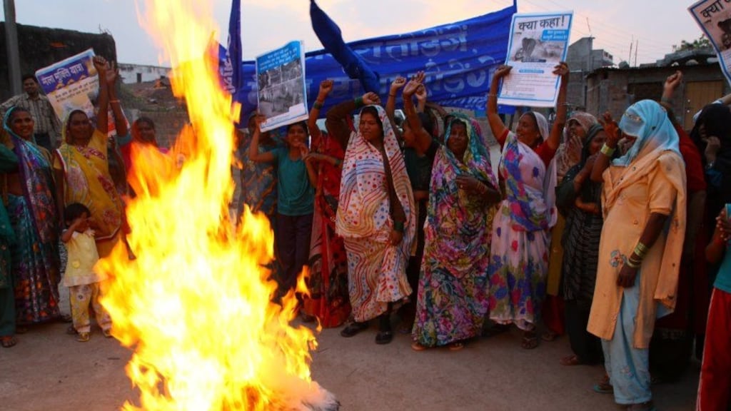 Dalit women ritually burn their manual scavenging baskets in Dewas, in the Indian state of Madhya Pradesh. Photograph: Pratap Rughani