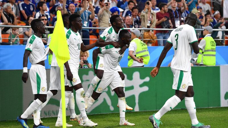 Senegal celebrate Moussa Wague’s second goal against Japan. Photograph: Dan Mullan/Getty